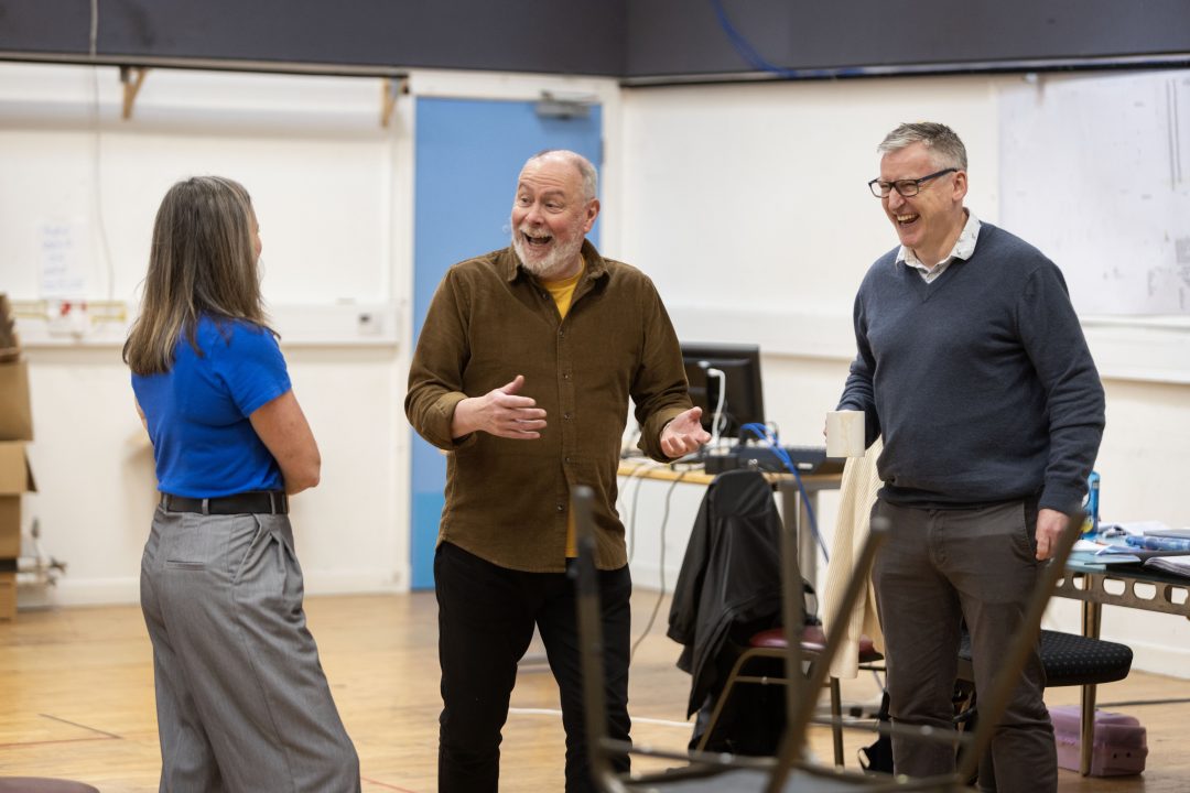 Actors Dawn Steele and Barrie Hunter share a laugh with director James Brining in a bright rehearsal room for 'Black Diamonds and the Blue Brazil'.