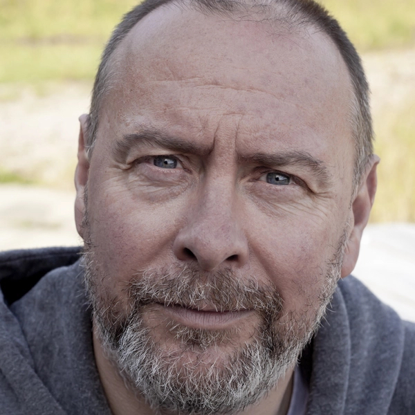 A headshot of actor Barrie Hunter, who is wearing a dark grey top.
