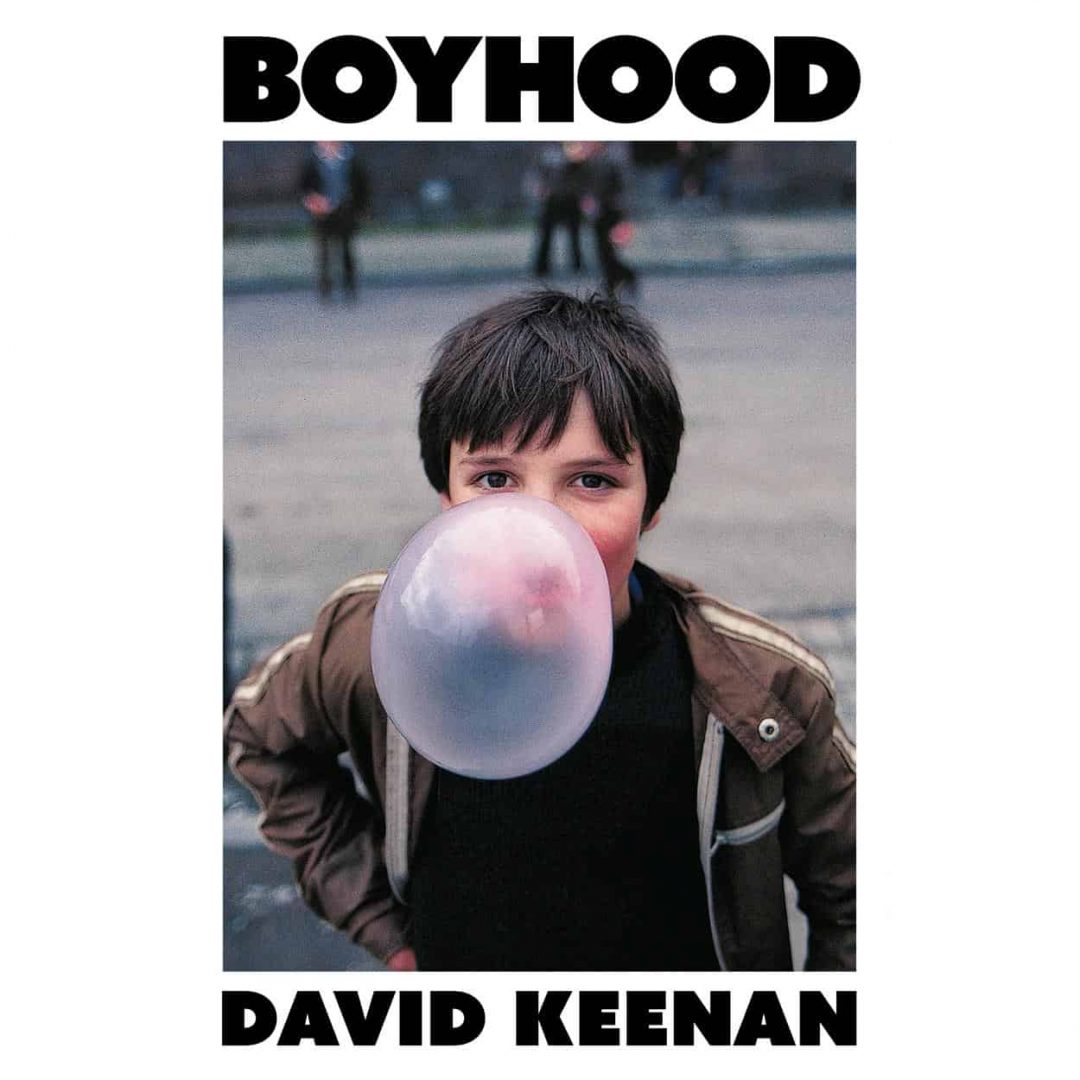 Book cover for 'Boyhood' by David Keenan, featuring a photograph of a young person blowing a large bubble gum bubble.