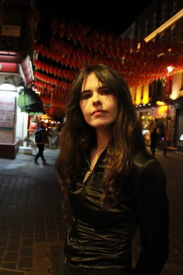 Promo photo of Frankie Morrow stood on a street after dark.