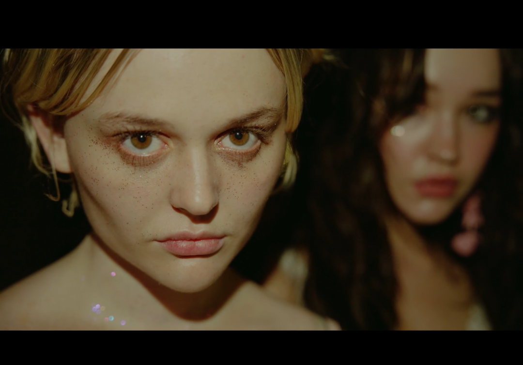 Still from Pretty Babies showing close-ups of two young women with glitter on their faces.