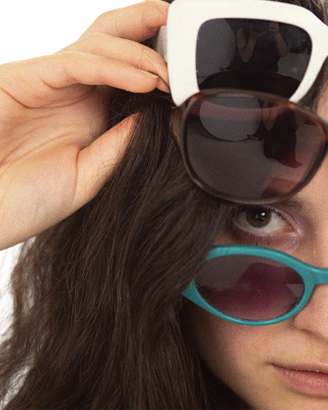 Musician Katerina stacking multiple pairs of sunglasses in front of her face.