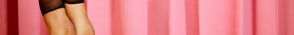 A promotional poster image for Pink Rabbit showing a woman lying on a pink surface with her legs up against a matching pink curtain backdrop.